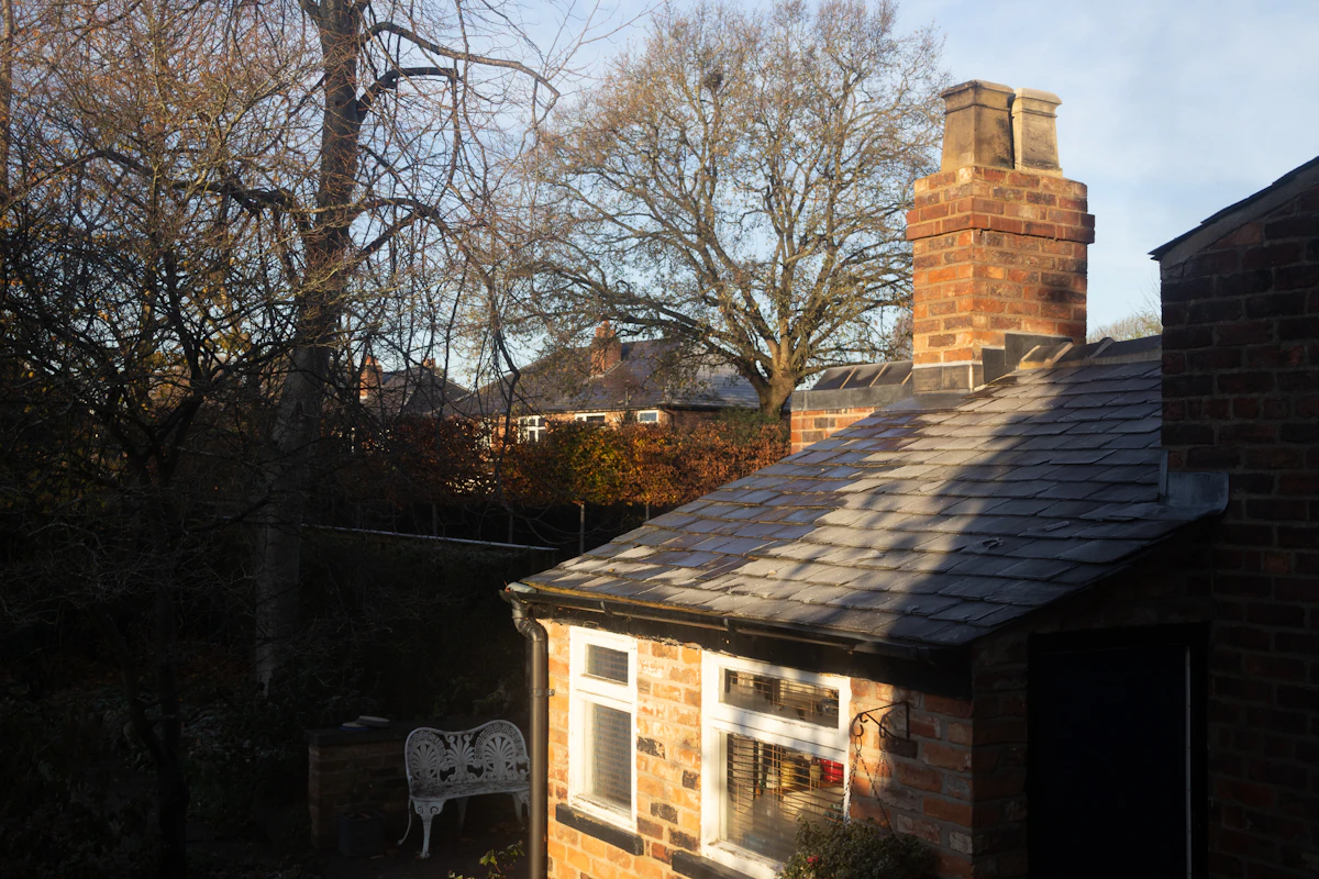 Slate roof and brick chimney on a house in warm afternoon light